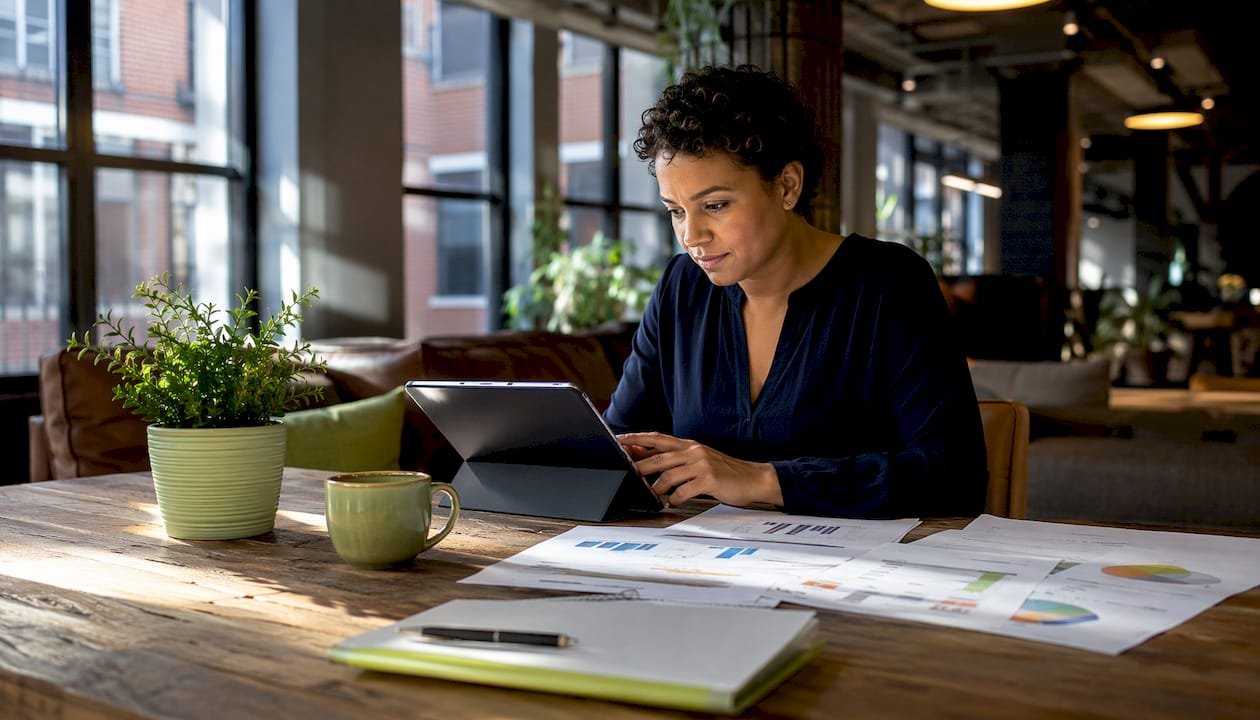 Woman reviewing invoices at office desk